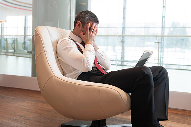 istock Stressed out businessman covers face with hands 467760535