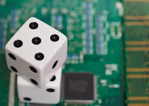 Pair of dice sitting on top of computer motherboard