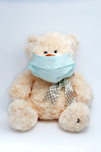 istock Toy bear wearing a mask 467763630