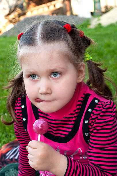 istock Little girl with candy 467763648