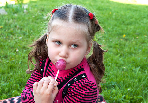 istock Little girl with candy 467763650