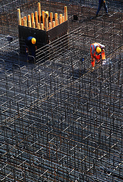 istock Manual worker welding concrete reinforcing steel on construction site 467765282