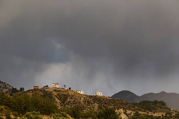 Rain Storm engulfing the houses on a hilltop stock photo
