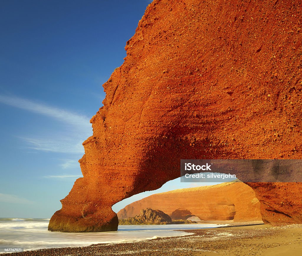 Red archs on atlantic ocean coast. Marocco Activity Stock Photo