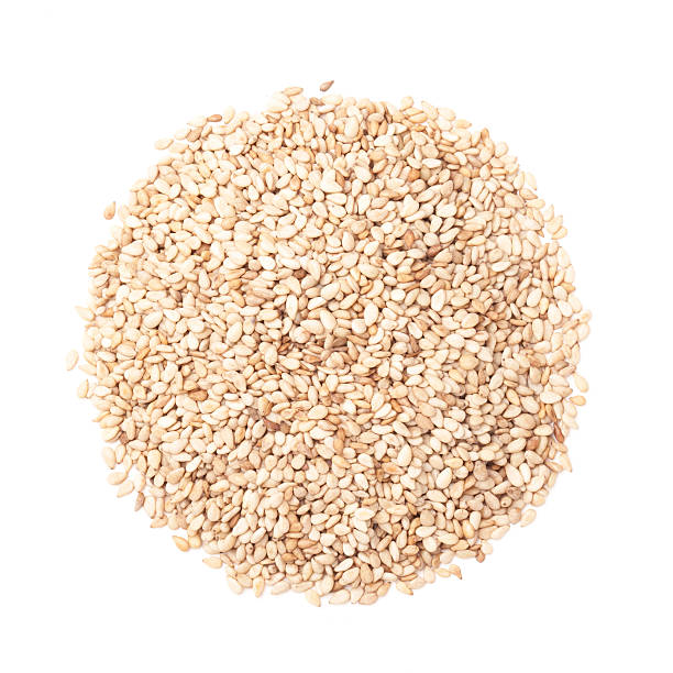 istock Sesame seeds isolated on white by top view 467767494