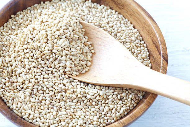 istock Organic natural sesame seeds on white wood table 467767850