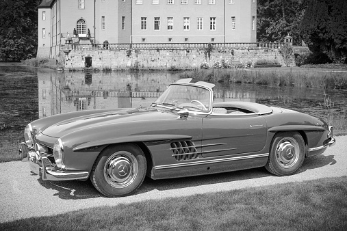 Jüchen, Germany - August 1, 2014: Mercedes-Benz 300SL Convertible classic sports car in the park in front of Schloss Dyck. The car is on display during the 2014 Classic Days event at Schloss Dyck. 