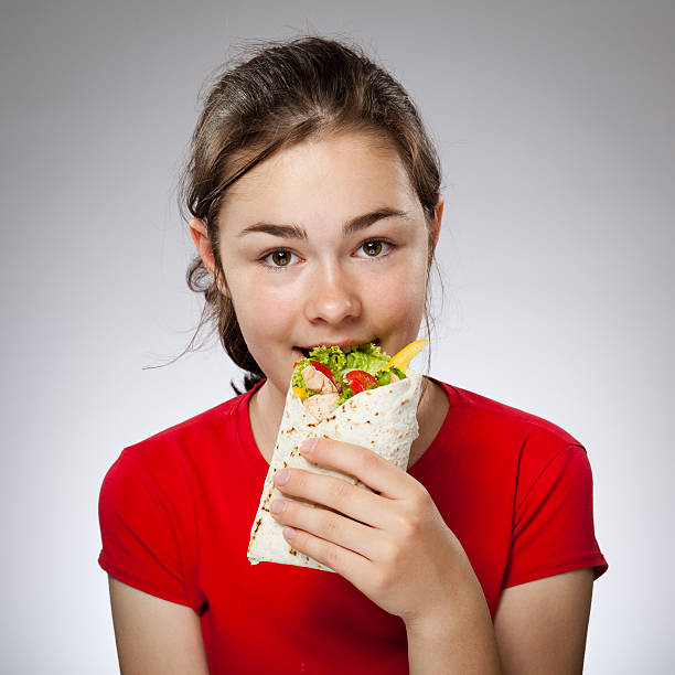 istock Girl holding sandwiches 467769572