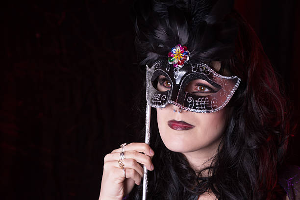 istock Young woman with mardi gras style mask with copyspace. 467769590