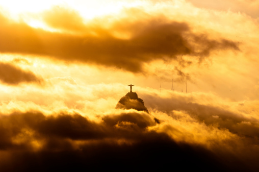 Corcovado Mountain with Christ the Redeemer Statue in Clouds on Sunset in Rio de Janeiro, Brazil.