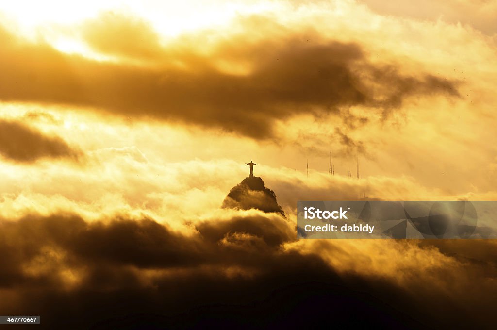 Christ the Redeemer Statue in Clouds Corcovado Mountain with Christ the Redeemer Statue in Clouds on Sunset in Rio de Janeiro, Brazil. Rio de Janeiro Stock Photo