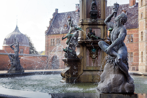 The famous Stork fountain and traditional old houses on the street in the center of Copenhagen, Denmark