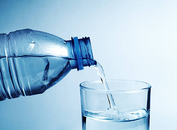 istock Cold water bottle pour water to glass 467772470