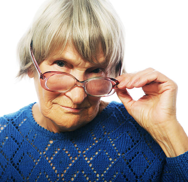 istock old senior lady looking through her eyeglasses 467772820