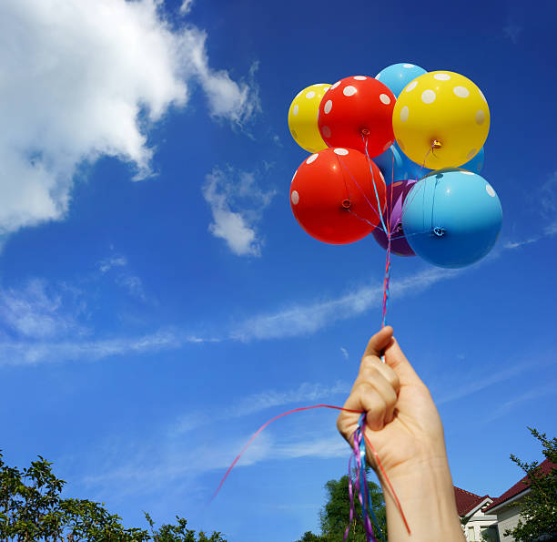 istock Colorful Balloons in front of a House 467773659