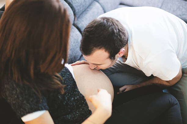 istock Future dad kissing his woman's pregnant belly 467773798