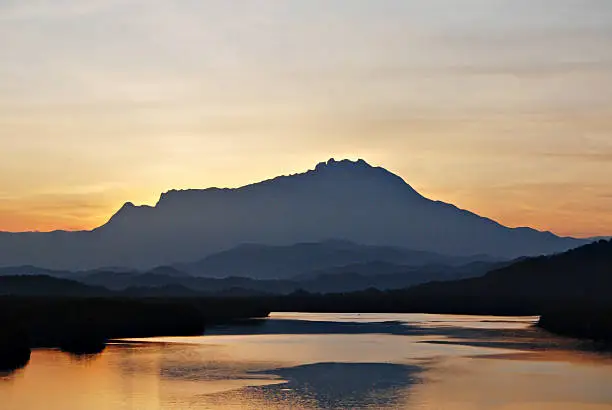 Photo of Silhouette of Mount Kinabalu during sunrise seen from Megkabong