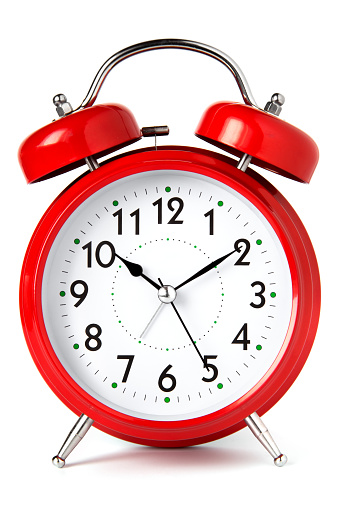 Red alarm clock on white background