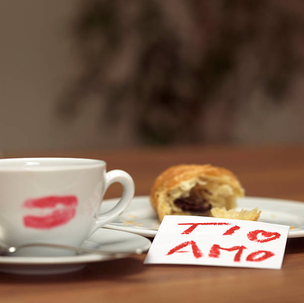 istock Cup of coffee with lipstick kiss, croissant and note 467774448