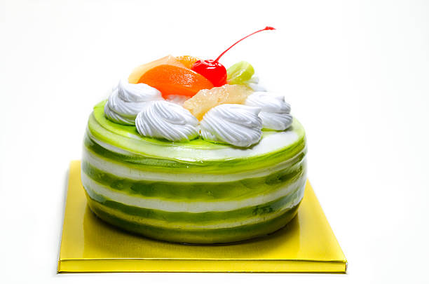 Chocolate cake decorated by mousse whipping cream and cherry on top, the image isolated on white 