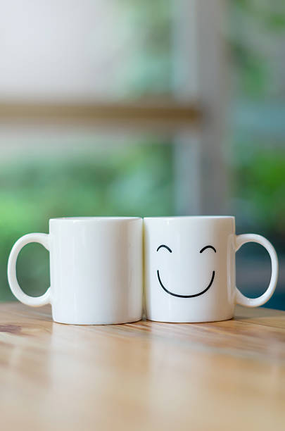 istock Two happy cups on wood table with bokeh, love concept 467777304