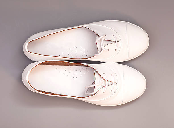 istock White Shoes isolated on gray  background 467777360