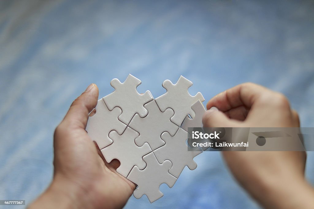 A white jigsaw puzzle in a person's hands file_thumbview_approve.php?size=3&id=34085898 Achievement Stock Photo