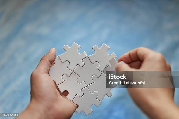 A White Jigsaw Puzzle In A Persons Hands Stock Photo - Download Image Now - Achievement, Adversity, Challenge