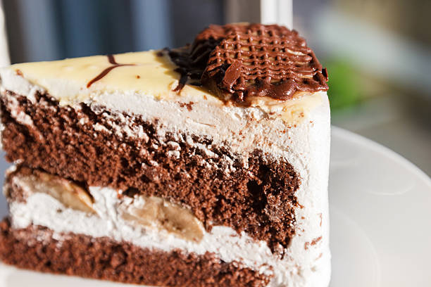 istock chocolate cake with cream and banana 467777436