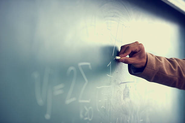 It's all greek to me! Cropped image of a teacher writing a formula on a blackboardhttp://195.154.178.81/DATA/istock_collage/0/shoots/782800.jpg math teacher stock pictures, royalty-free photos & images