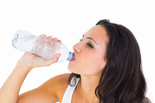 istock Pretty brunette drinking bottle of water 467780298
