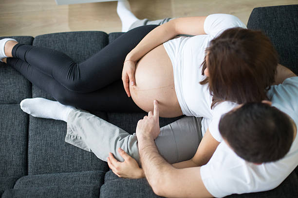 istock The hands of mom and dad touching the belly 467780926