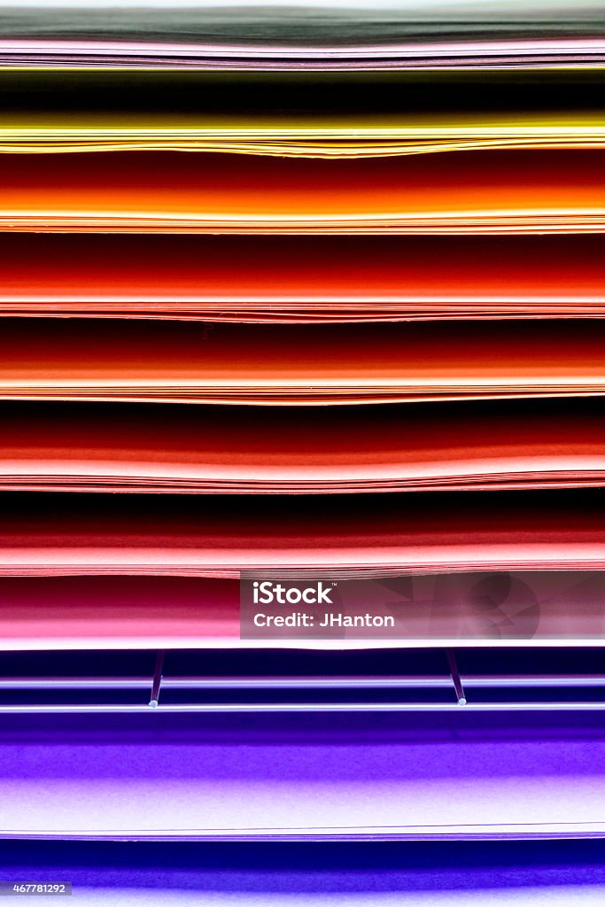 Multi Coloured Paper Rainbow A horizontal store display of sheets of coloured paper showing a spectrum of rainbow colours. 2015 Stock Photo