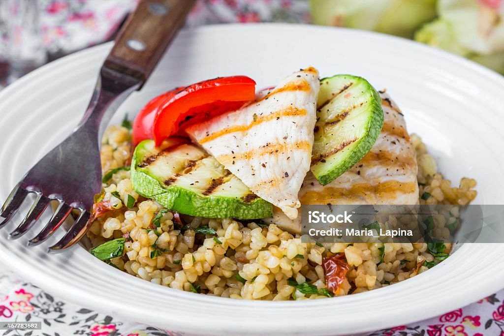 Bulgur with vegetables and grilled chicken, healthy, diet summer Bulgur with vegetables and grilled chicken, healthy, diet tasty summer dish Chicken Meat Stock Photo
