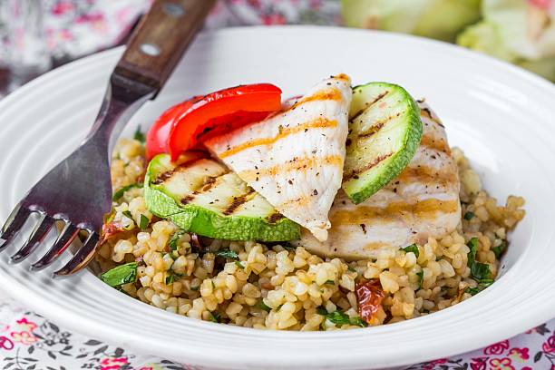 Bulgur with vegetables and grilled chicken, healthy, diet summer stock photo