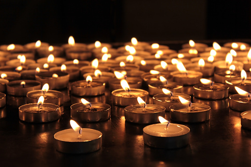 burning memorial candles on dark background