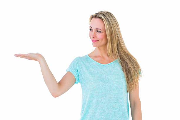 istock Pretty blonde smiling with hand out 467786028