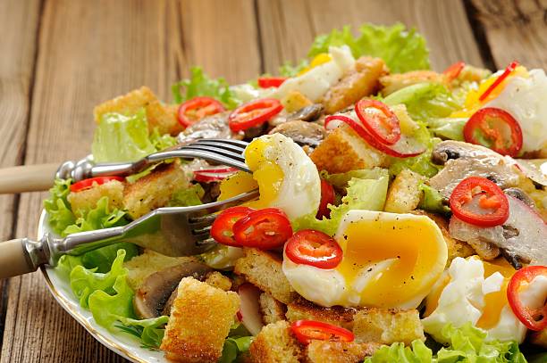 istock Salad Caesar with mushrooms, eggs, chili and radish closeup 467786542