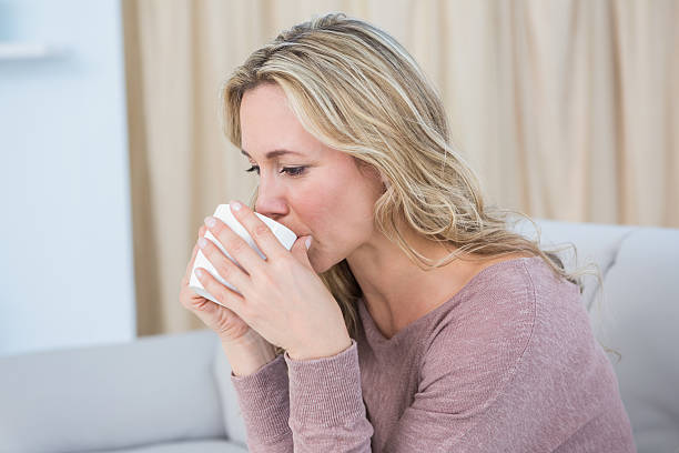 istock Pretty blonde sitting on couch drinking coffee 467787466
