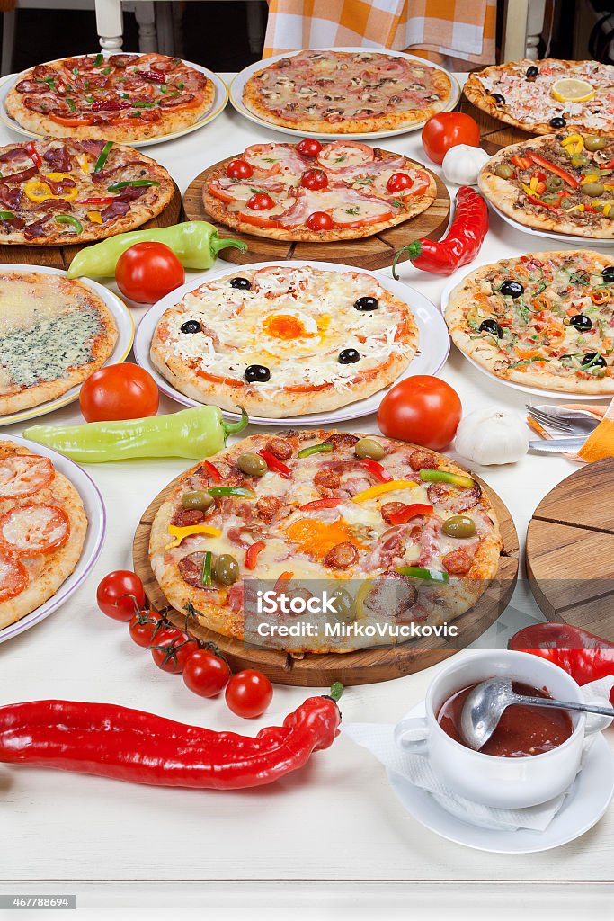 Table full of pizza Several kinds of pizza served on the table. Pizza Stock Photo