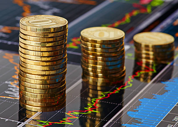 istock Down trend stacks of coins and financial chart as background 467789065
