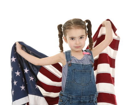 little girl holding up an American flag