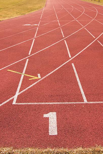 istock White lines and texture of running racetrack, red rubber racetracks 467794532