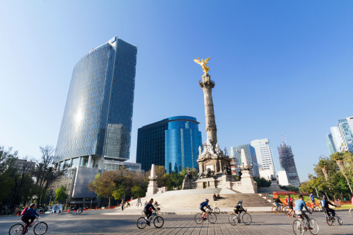 Mexico City, Mexico - February 2, 2014: Bikers at the Mexico City sunday ride along Paseo de la Reforma, in front of the Independence Angel. On sundays the avenue is closed to transit an is full of bikers, runners and families working out or doing outdoors activities.