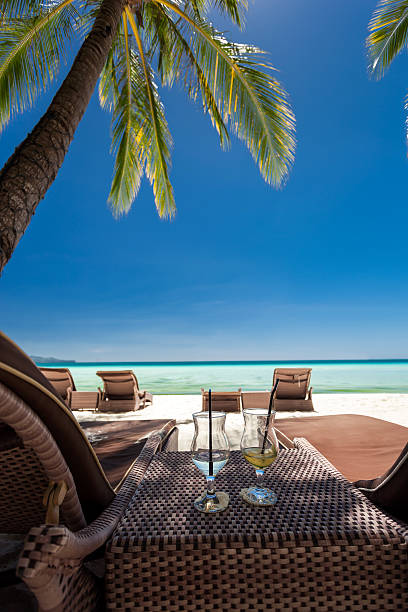 istock Two glasses with finished up cocktails on tropical beach 467796116