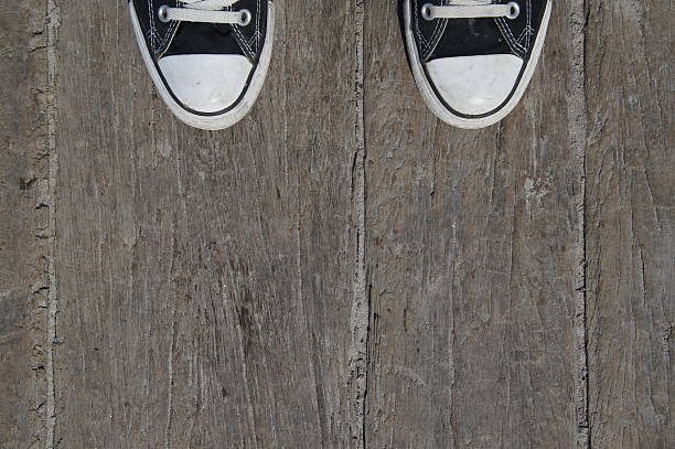 istock Black canvas sneakers on wood 467799088