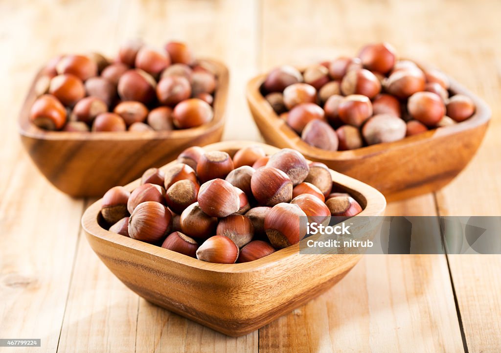 bowl of hazelnuts bowl of hazelnuts on wooden table 2015 Stock Photo