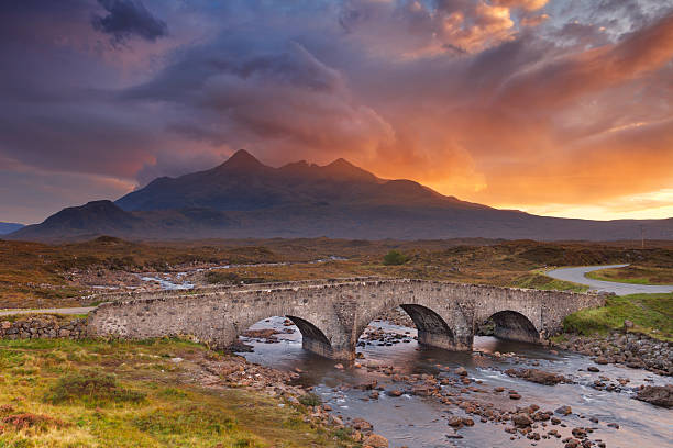 Sligachan Bridge and The Cuillins, Isle of Skye at sunset The Sligachan Bridge with The Cuillins in the background on the Isle of Skye, Scotland. Beautiful clouds, photographed at sunset. isle of skye stock pictures, royalty-free photos & images