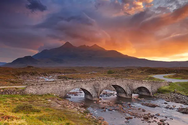 The Sligachan Bridge with The Cuillins in the background on the Isle of Skye, Scotland. Beautiful clouds, photographed at sunset.
