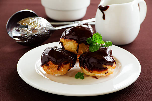 istock profiteroles with cream and chocolate sauce. 467802348
